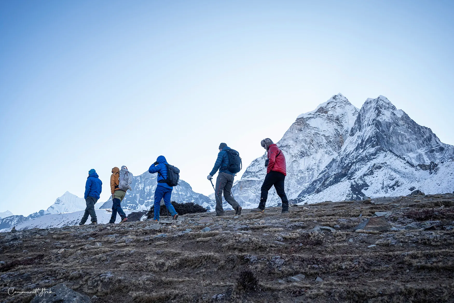Team trekking toward Everest Base Camp on a snowy winter trail.