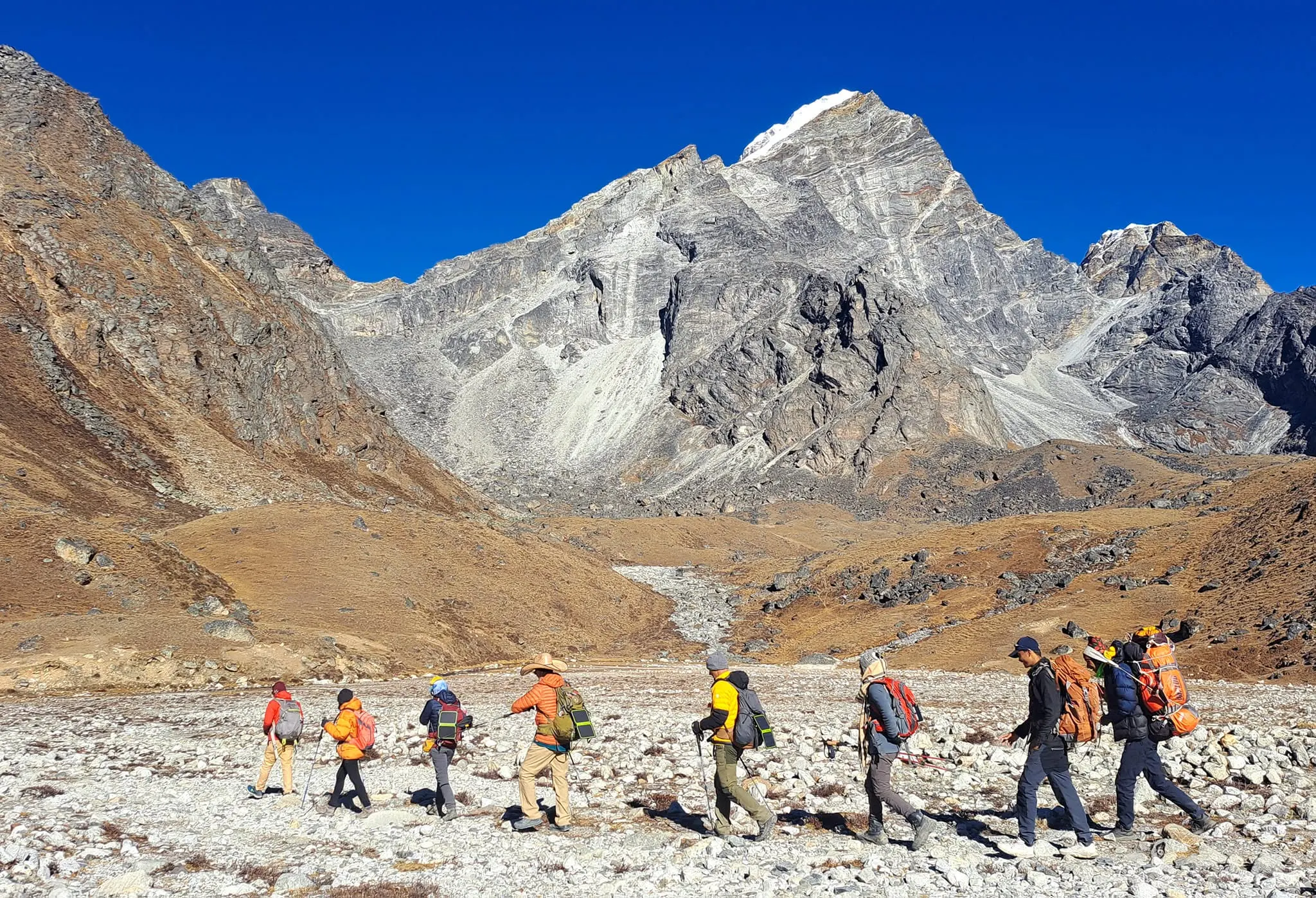 Trekkers walking toward Cho La Pass through the Gokyo Valley in Nepal