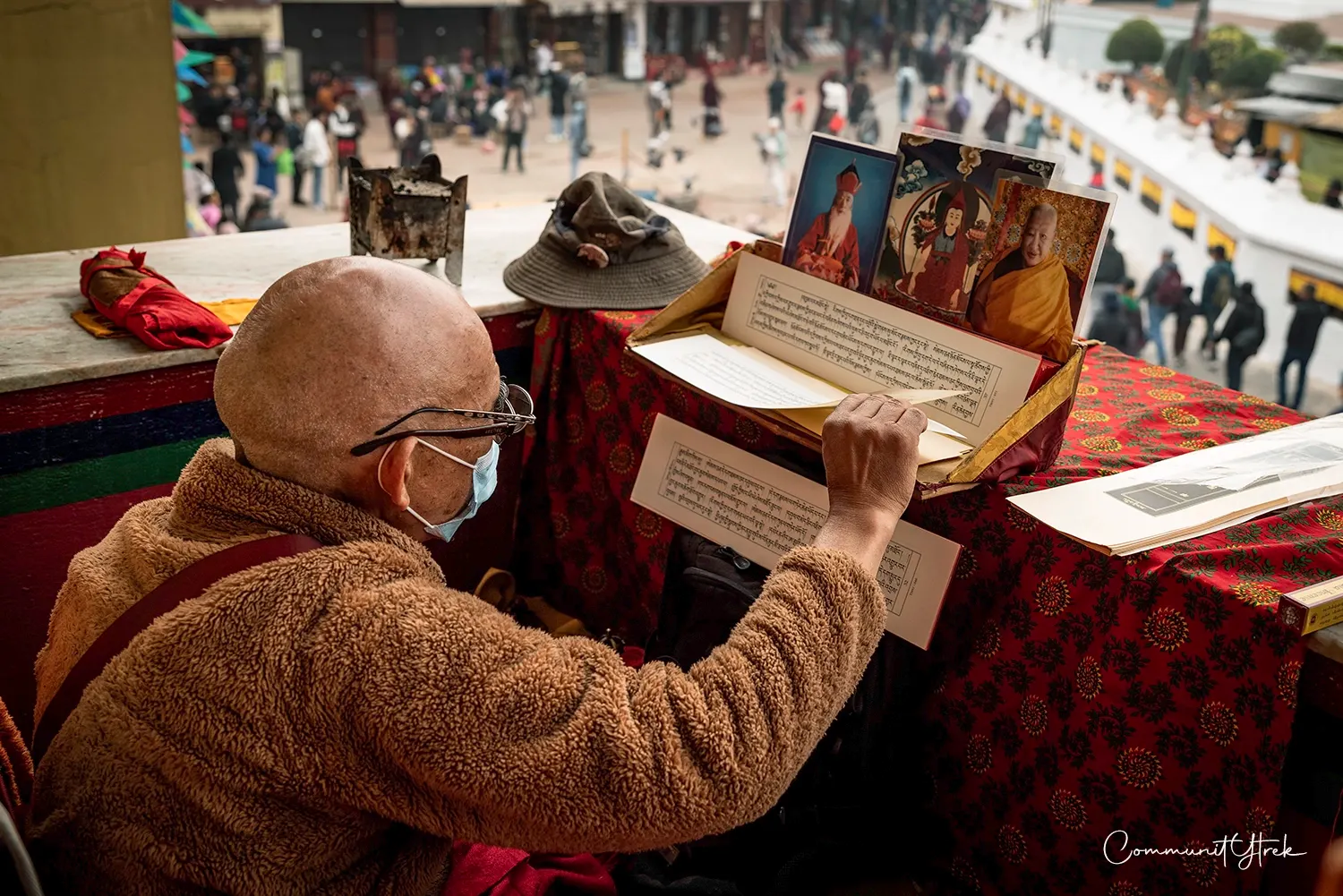 Buddhist monk chanting and reading Buddhist texts at Boudhanath Stupa in Kathmandu